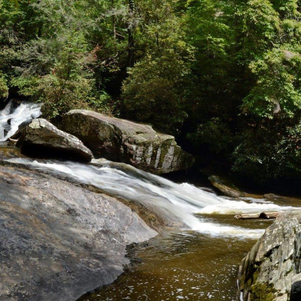 a large waterfall over a rocky cliff