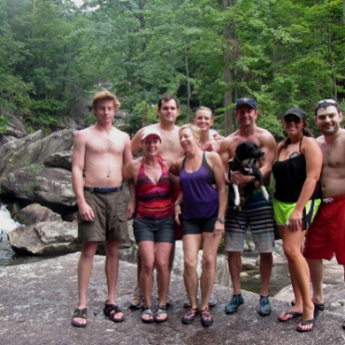 a group of people standing next to a river