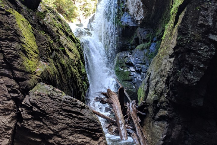 a large waterfall over a rocky cliff