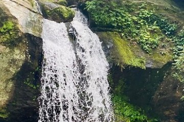 a large waterfall over some water
