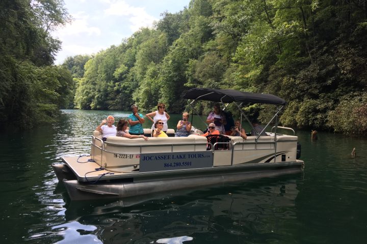 a group of people in a small boat in a body of water
