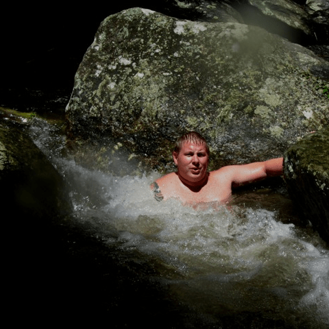 a young man riding a wave on a surfboard in the water