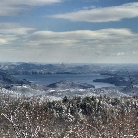 a man standing on top of a snow covered mountain
