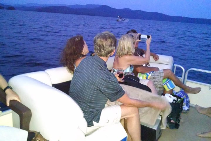 a man and woman sitting next to a body of water