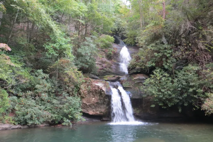 a large waterfall over a body of water