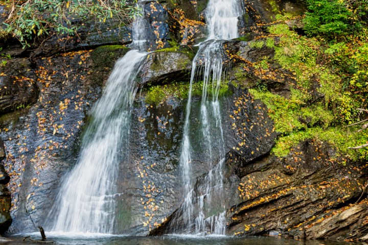 a large waterfall over some water