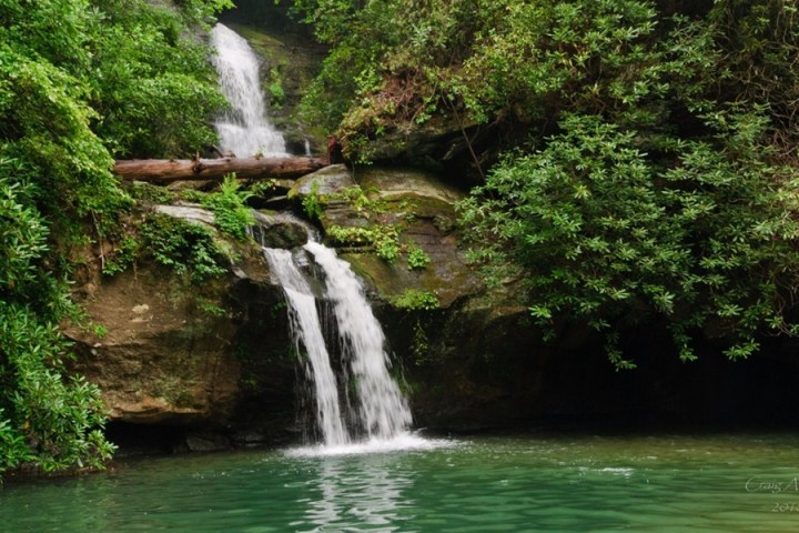 a large waterfall over a body of water