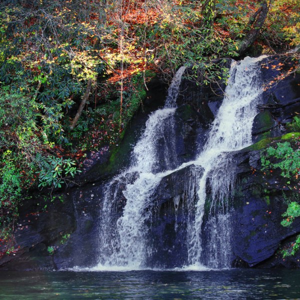 a large waterfall over some water
