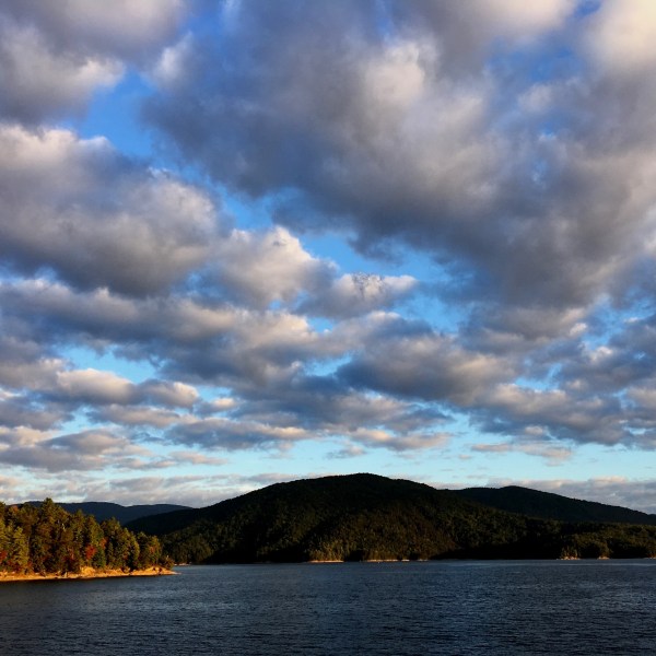a large body of water with a mountain in the background