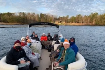 a group of people in a boat on a body of water
