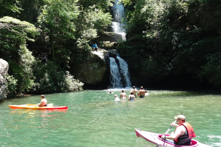 a group of people rowing a boat in the water