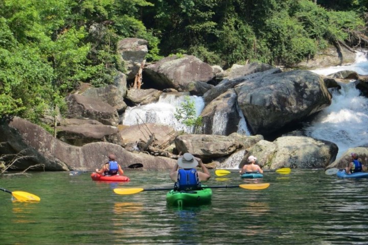 a group of people on a raft in the water