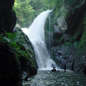a large waterfall over a river