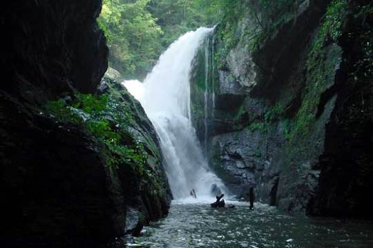 a large waterfall over a river