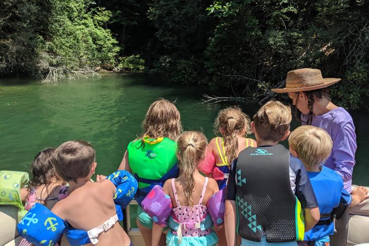 a group of people standing next to a river