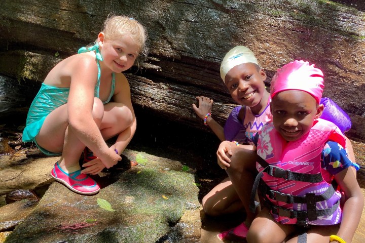 a little girl that is sitting on the ground