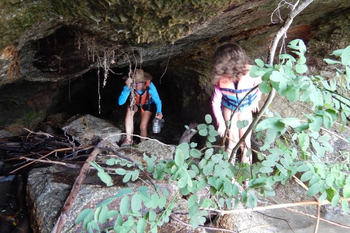 a young boy standing on a rock