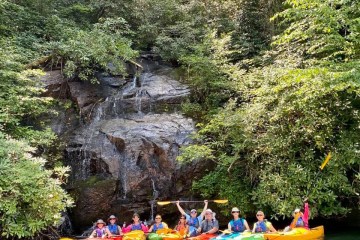 a group of people riding on the back of a boat