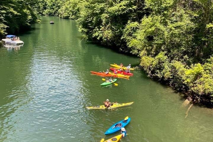 a group of people riding on the back of a boat in the water