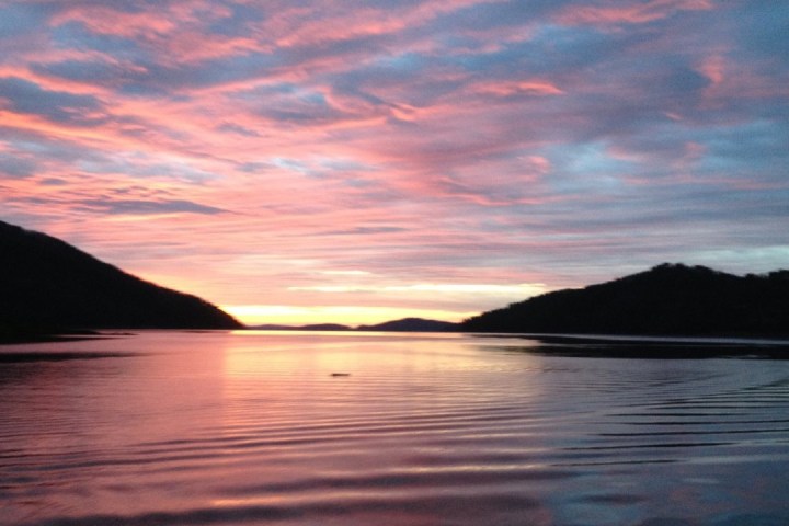 a sunset over a body of water