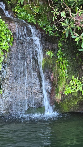 a large waterfall over some water