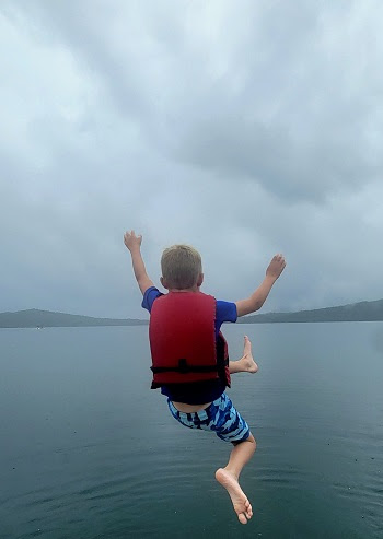 a person standing next to a body of water