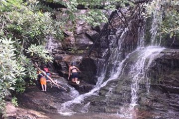 a large waterfall over a body of water