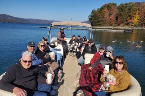 a group of people sitting in a boat on a body of water