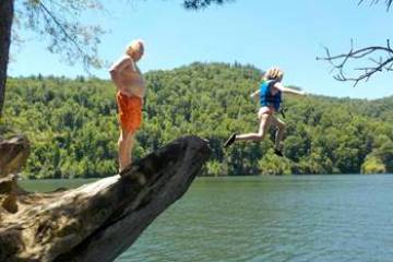 a group of people standing next to a body of water