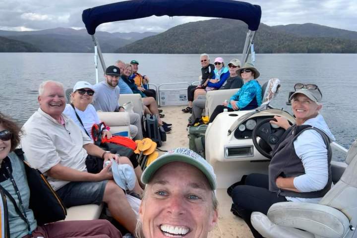 a group of people in a boat on a body of water