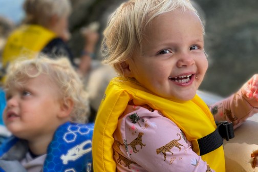 a little girl holding a baby