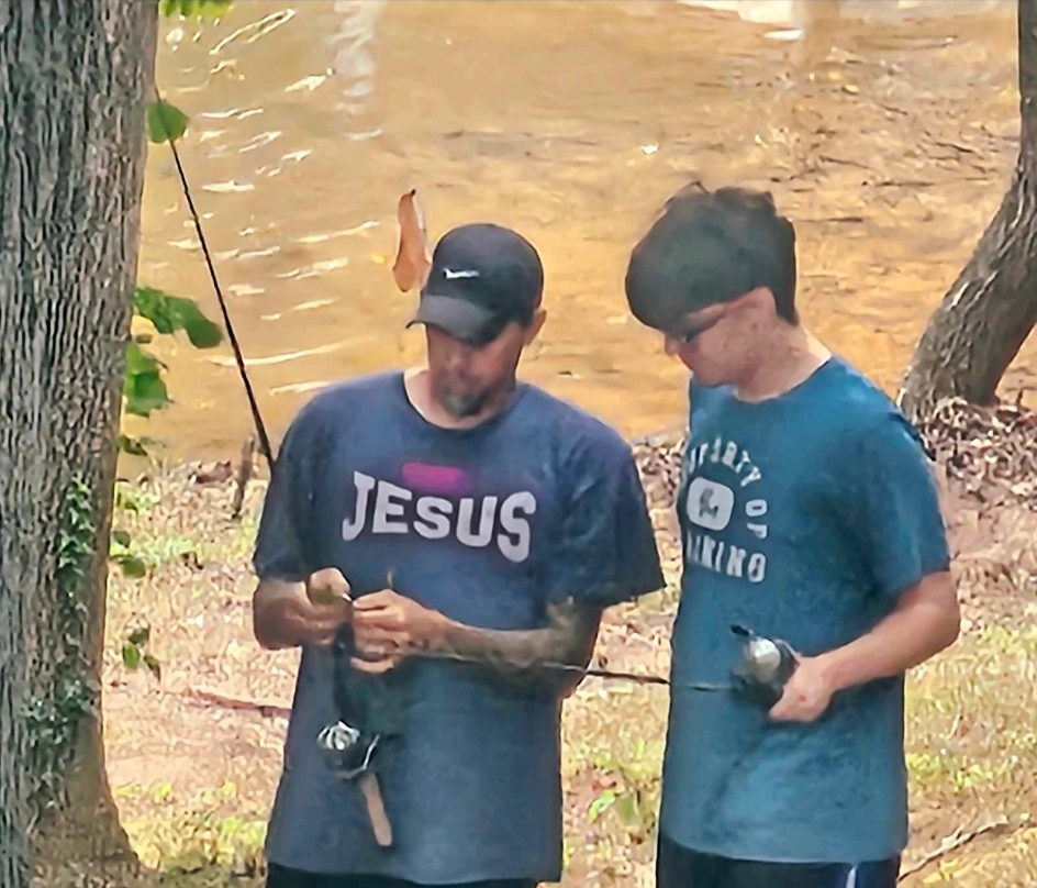 a couple of people that are standing in the grass