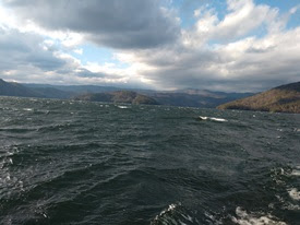 a body of water with a mountain in the background