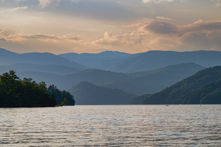 a large body of water with a mountain in the background