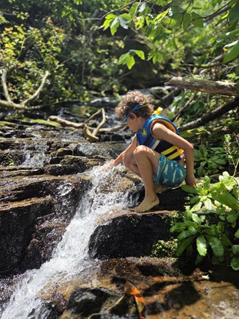 a person sitting next to a waterfall