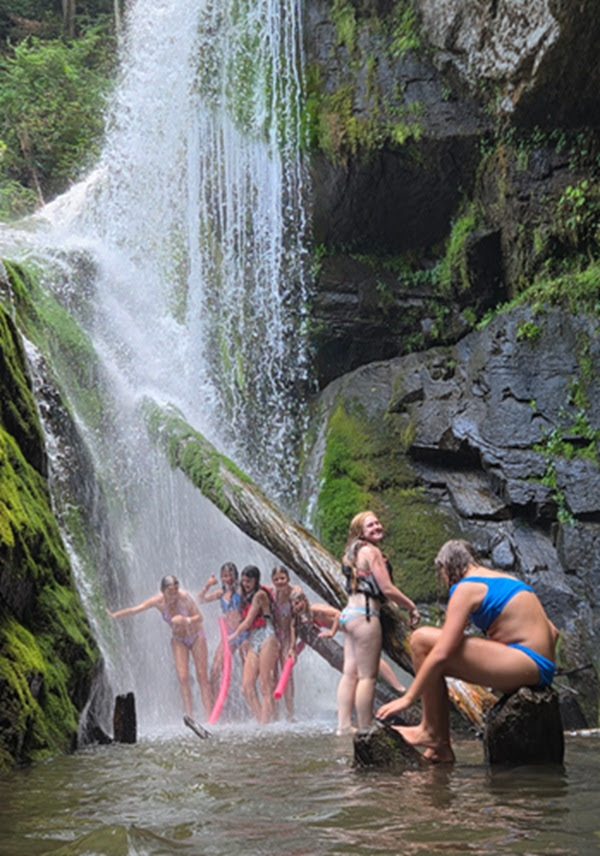 a group of people riding on top of a river
