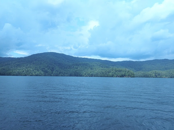 a large body of water with a mountain in the background